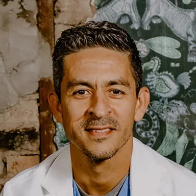 A professional headshot photo of Dr. Juan Escobar